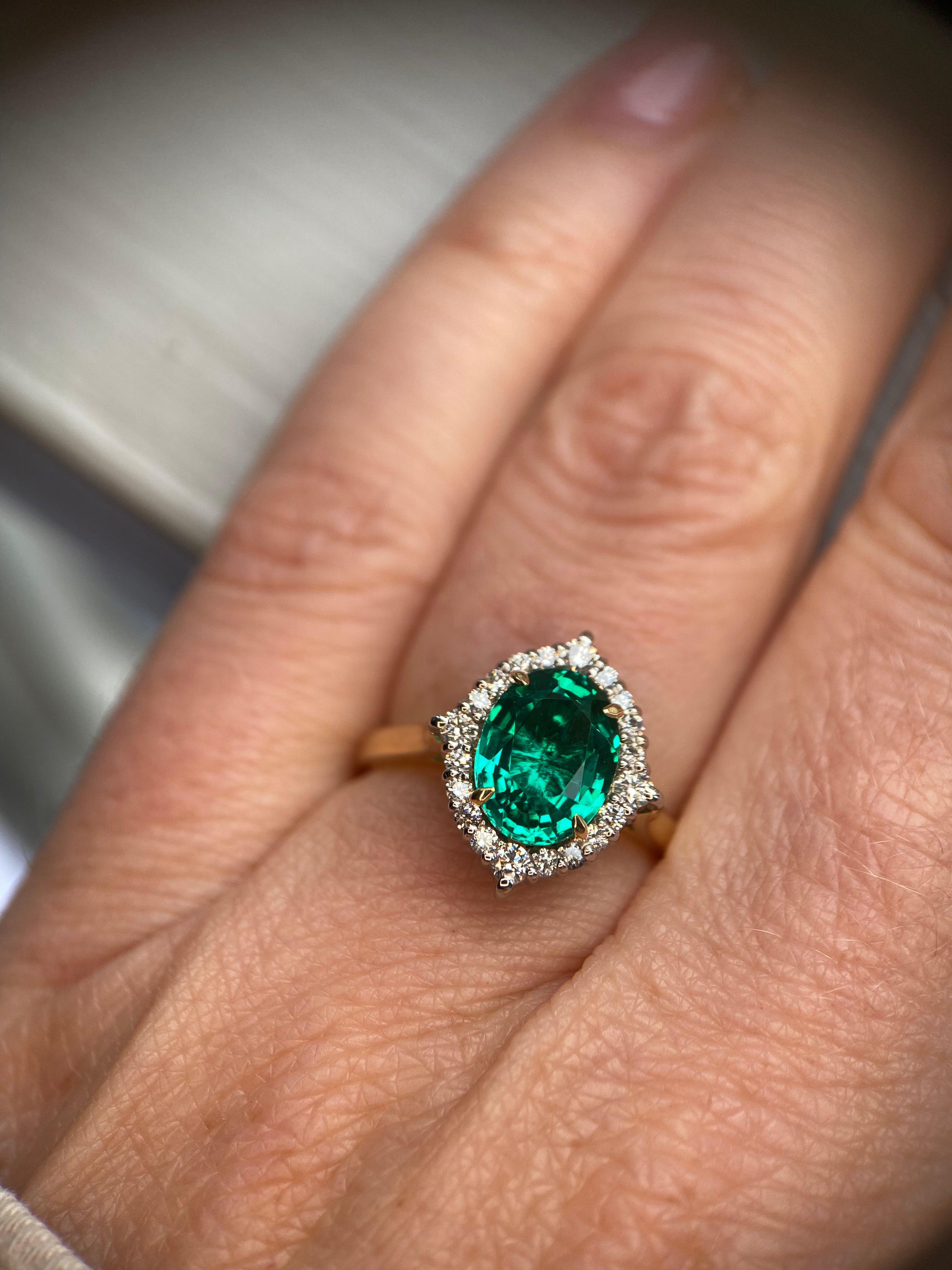 Green engagement ring with emerald centre stone and lab-grown diamond accents