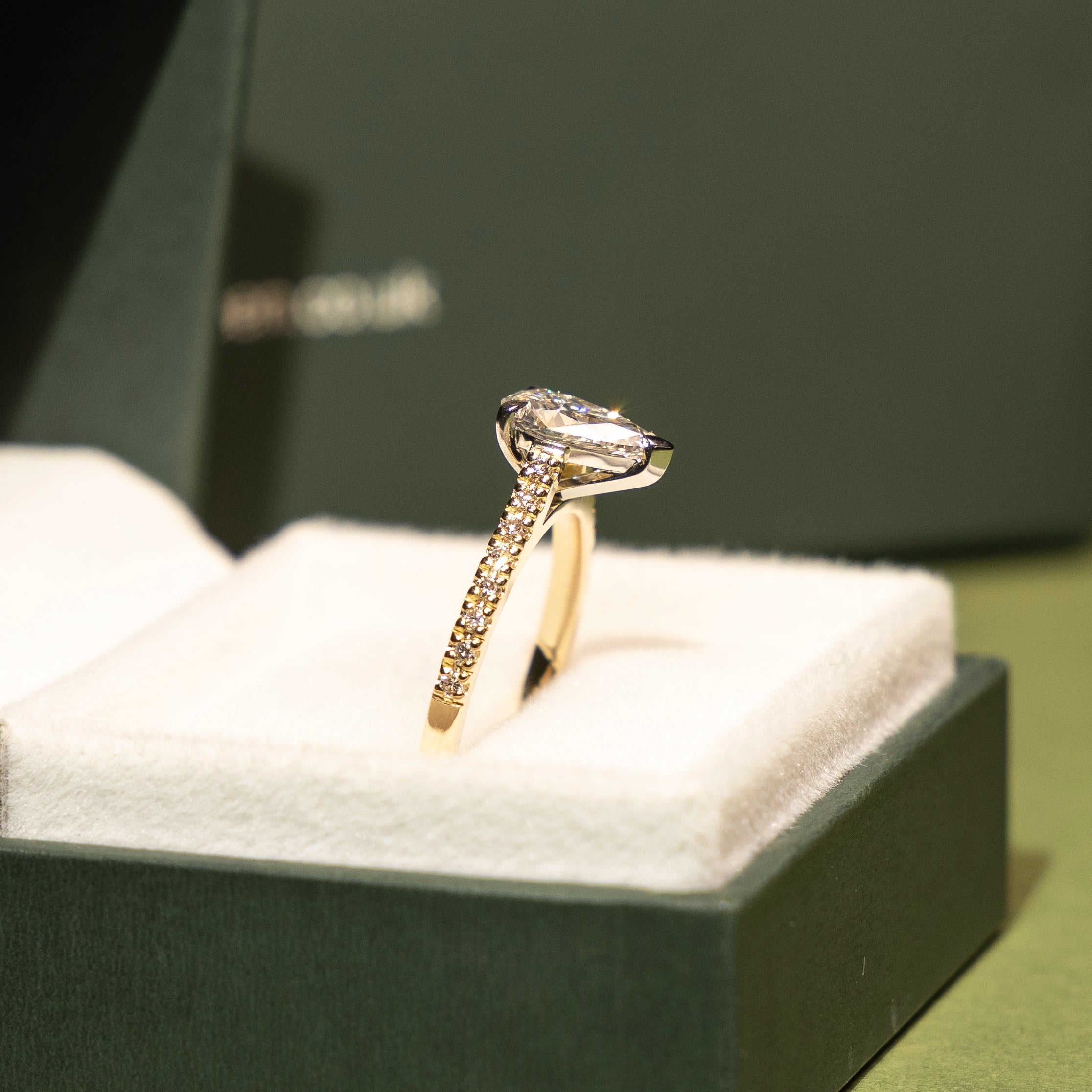 Diamond ring on a cushioned box with a blurred background