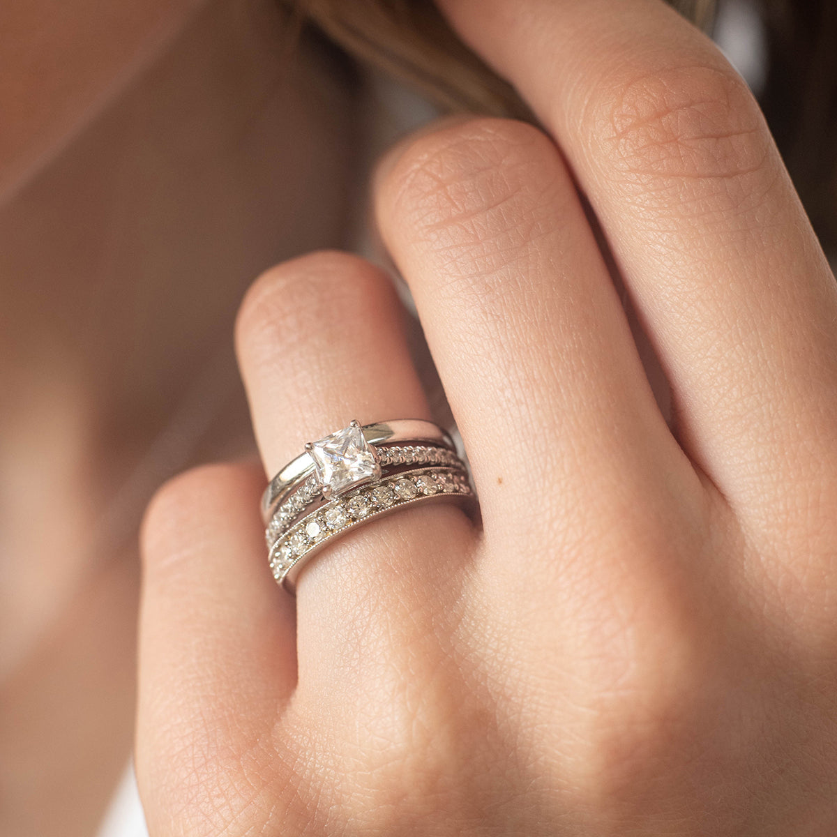 a person is holding a pair of black shoes