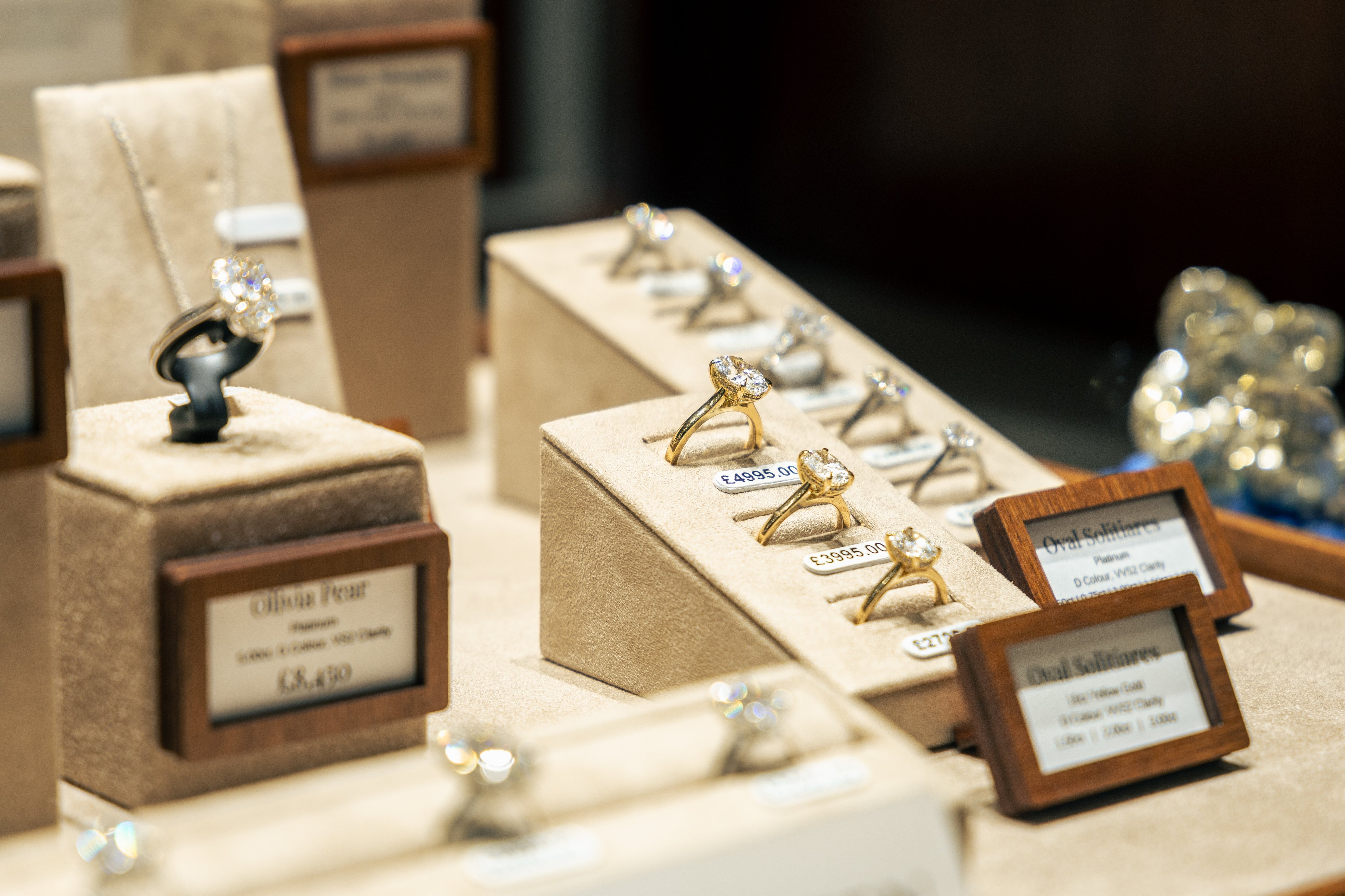 A selection of Olivia Green’s most unique engagement rings displayed on velvet