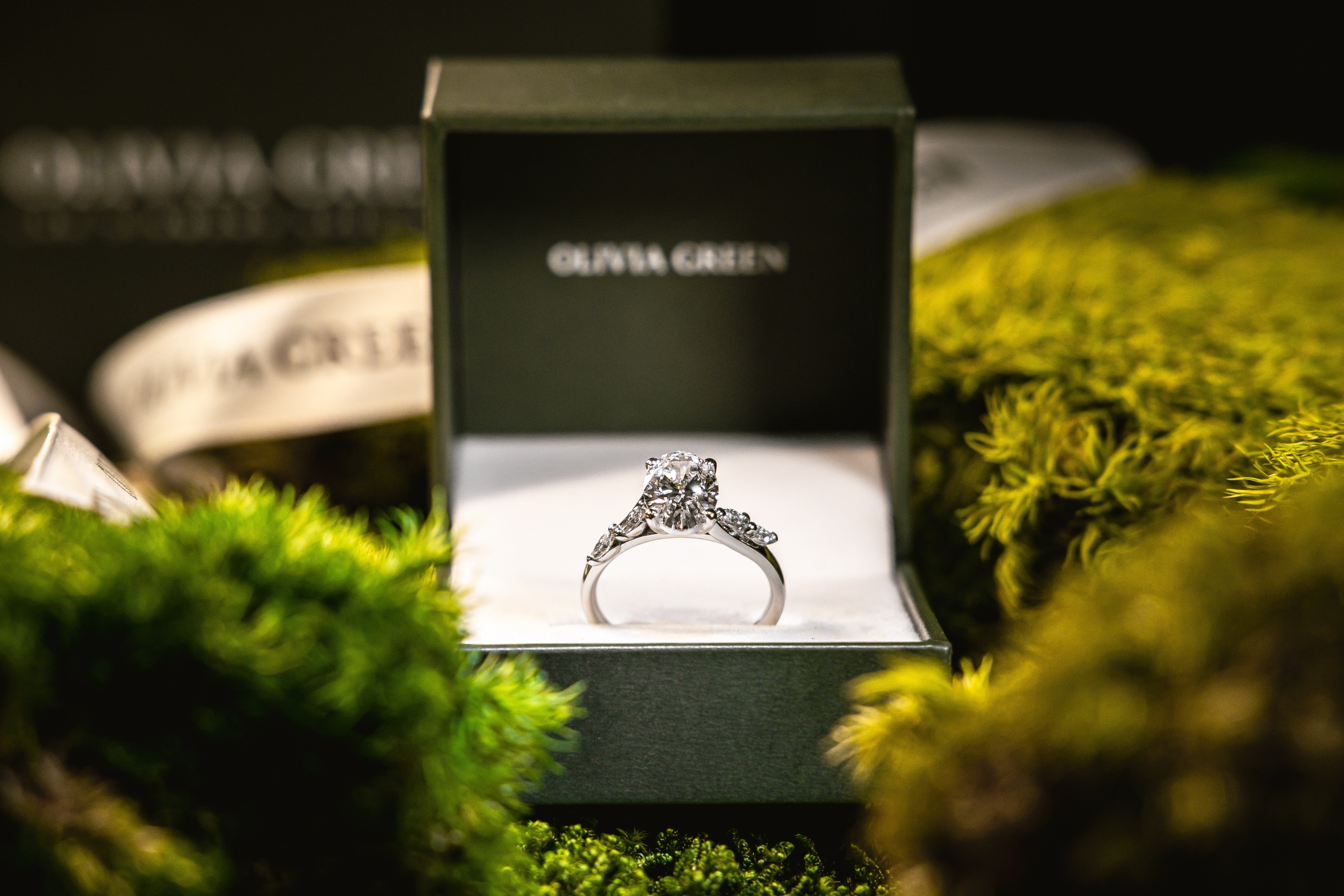 A selection of platinum engagement rings with lab-grown diamonds on a marble slab