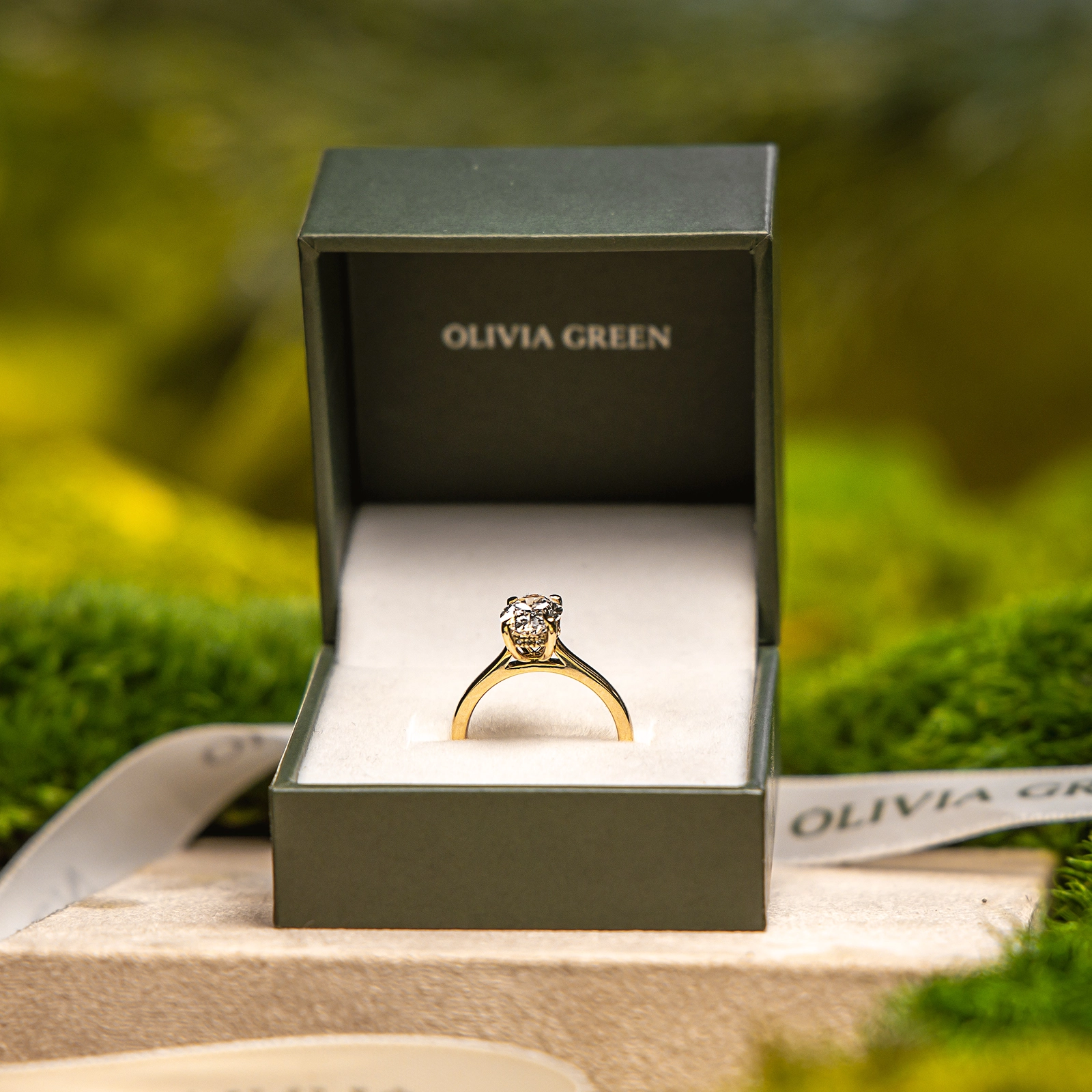 A gift box opened to reveal a diamond pendant and matching earring set
