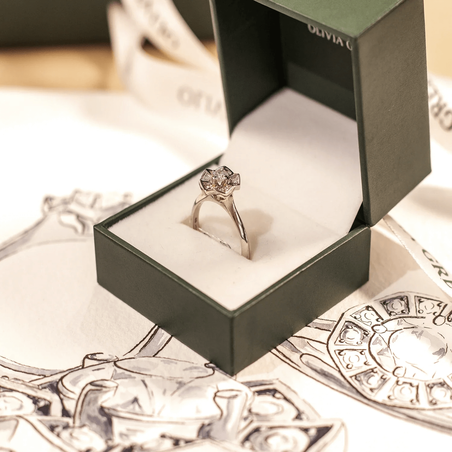 Engagement ring selection beside a design sketch